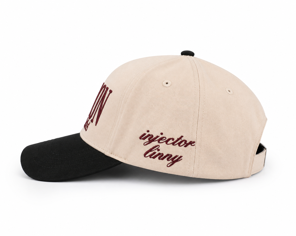 Beige and black cap with 'injector linny' text on a white background